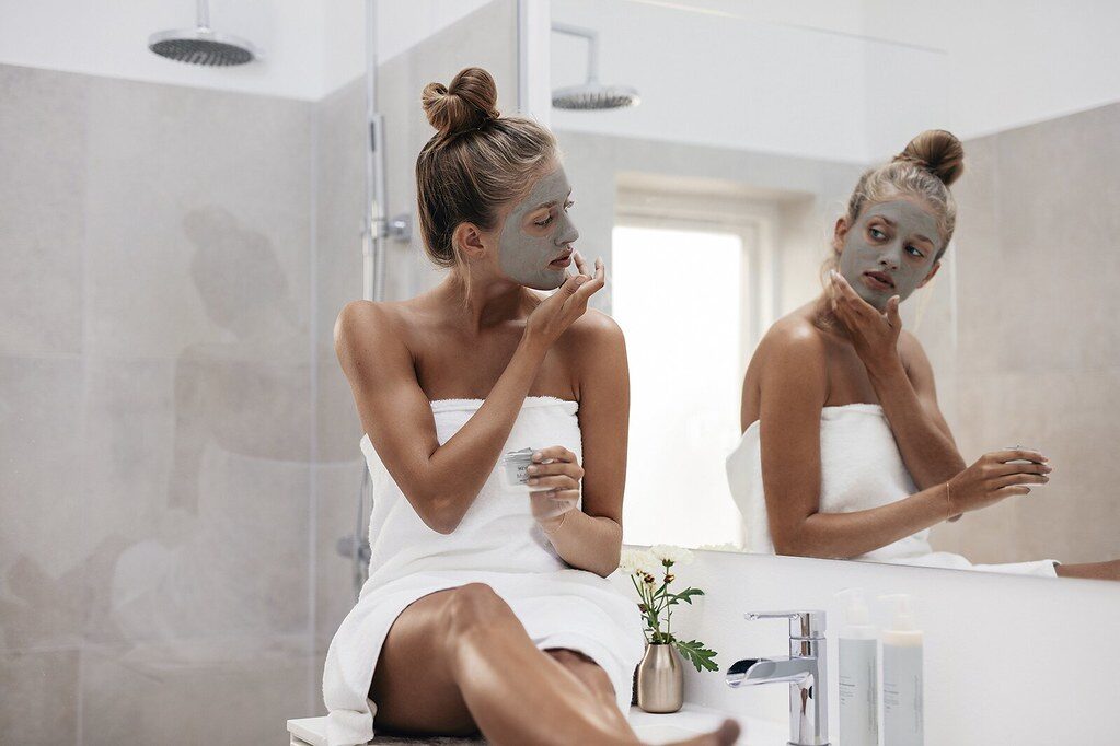 Woman applying a facial skincare mask